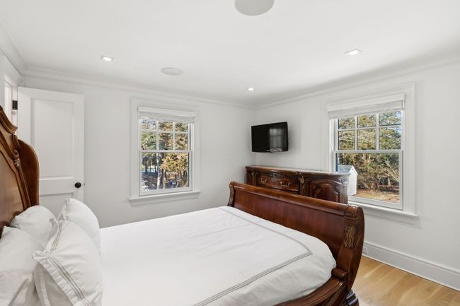 Bedroom featuring light hardwood / wood-style floors, ornamental molding, and multiple windows | Image 36