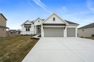 View of front facade featuring a garage, central AC, and a front yard | Image 1