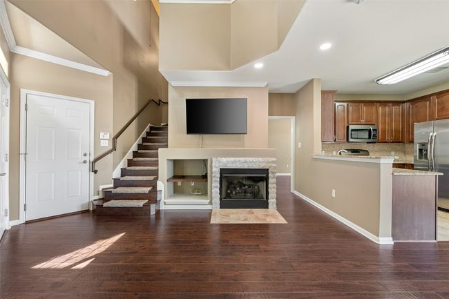 Kitchen with breakfast bar, stainless steel appliances, backsplash, and tall cabinetry | Image 10