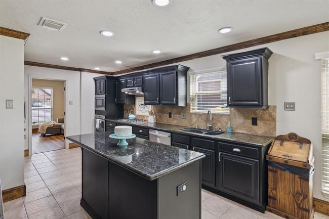Beautiful crown molding adds to the style of this home. Granite counter tops. | Image 13