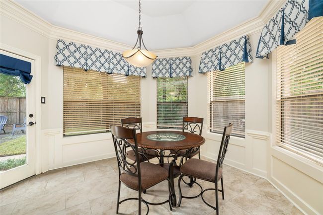Surrounded by windows and framed by a recessed ceiling, the breakfast nook offers a light-filled corner of the home that’s perfect for slow mornings, casual meals, or catching up over coffee. | Image 21