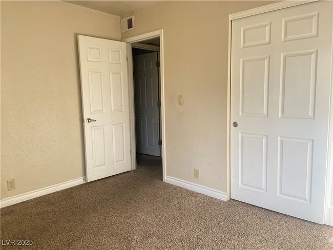 Unfurnished bedroom with carpet flooring, baseboards, visible vents, and a closet | Image 12