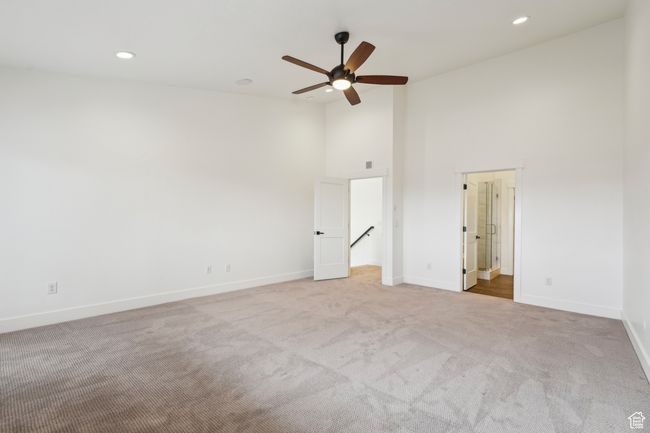 Unfurnished bedroom with high vaulted ceiling, recessed lighting, baseboards, and carpet | Image 26