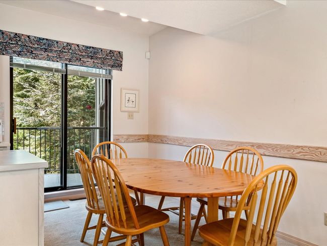 Dining space featuring light carpet | Image 11