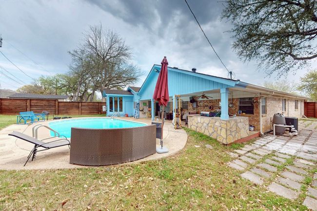 View of pool with a patio, a fenced in pool, a fenced backyard, ceiling fan, and outdoor dry bar | Image 36