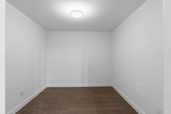 Empty room featuring dark wood finished floors and baseboards | Image 9