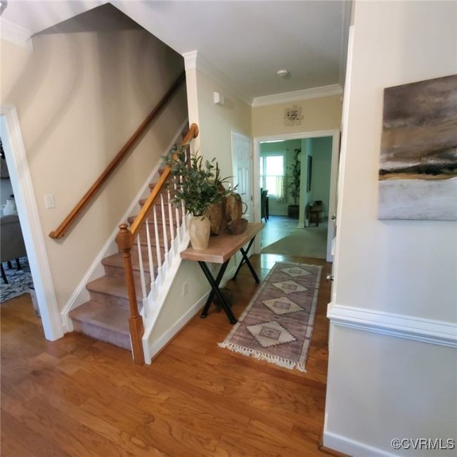 Staircase featuring crown molding and wood finished floors | Image 29