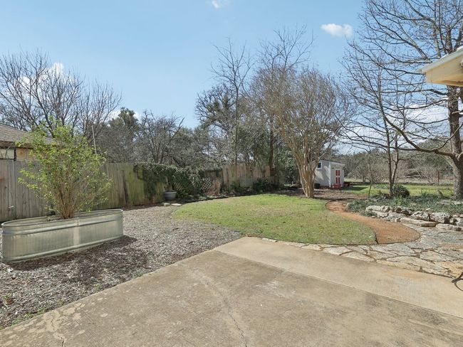 View of yard with a storage shed, a patio, an outbuilding, and a fenced backyard | Image 37