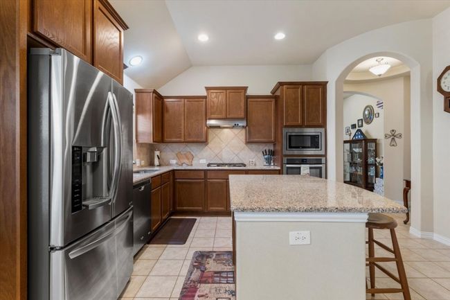 The stainless refrigerator can convey with sale. | Image 11