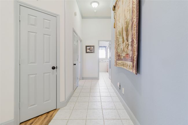 Hallway featuring ornamental molding and light tile patterned floors | Image 26