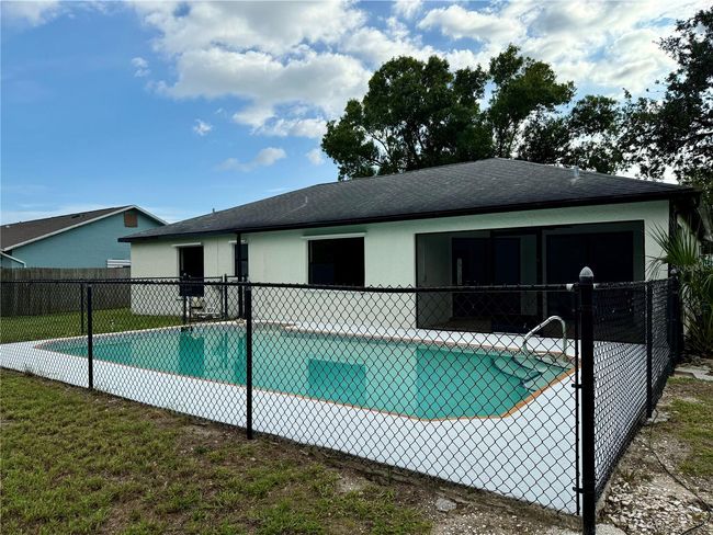 A relaxing escape — enjoy meals, gatherings, or quiet mornings from the screened patio overlooking the pool | Image 13