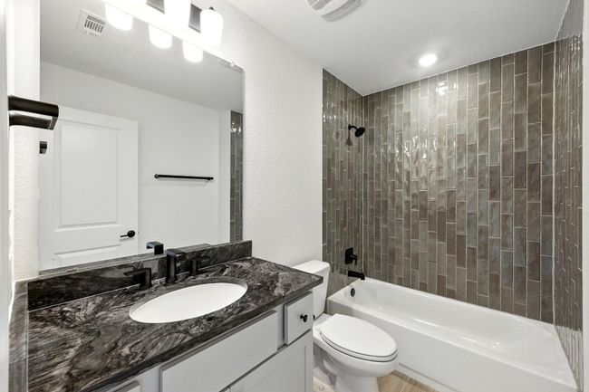 Bathroom with toilet, bathtub / shower combination, and vanity | Image 27