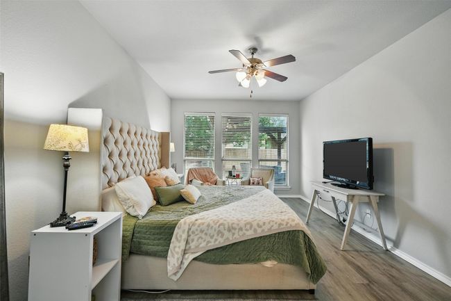 Bedroom with wood finished floors and a ceiling fan | Image 29