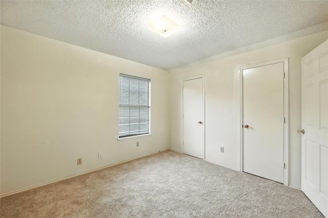 Unfurnished bedroom featuring carpet and a textured ceiling | Image 32