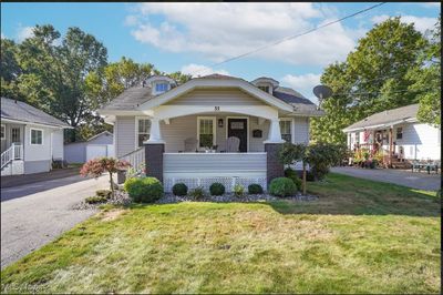 Bungalow with a front lawn and a porch | Image 1