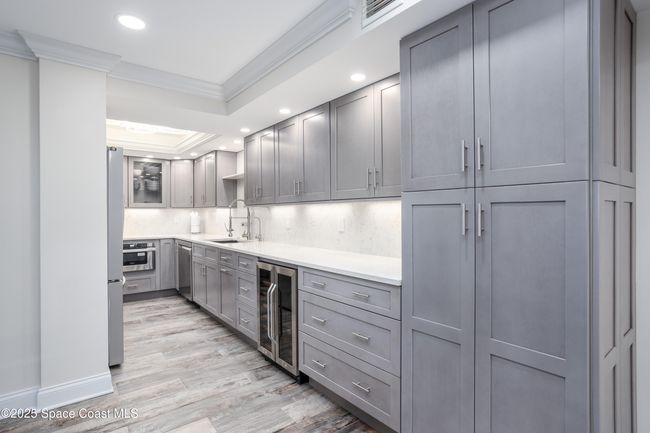 Well done kitchen and additional cabinetry extends to make longer with a pantry. | Image 13