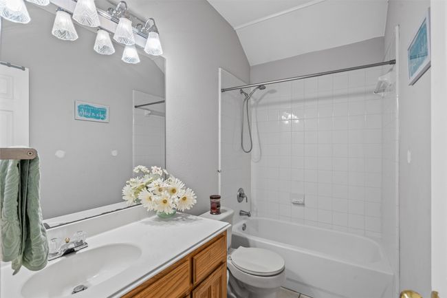 Bathroom with vanity, shower / bath combination, toilet, and vaulted ceiling | Image 17