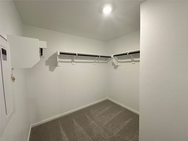 Spacious closet featuring dark carpet | Image 13