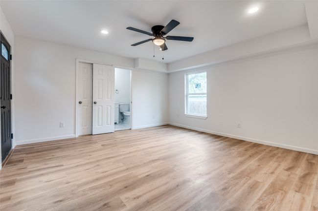Unfurnished bedroom with recessed lighting, a ceiling fan, light wood-style floors, ensuite bath, and baseboards | Image 18
