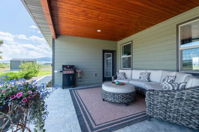 View of patio with area for grilling, outdoor lounge area, and a mountain view | Image 5