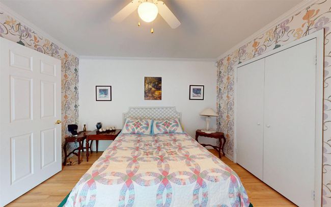 Bedroom featuring ornamental molding, light wood finished floors, a closet, and a ceiling fan | Image 38