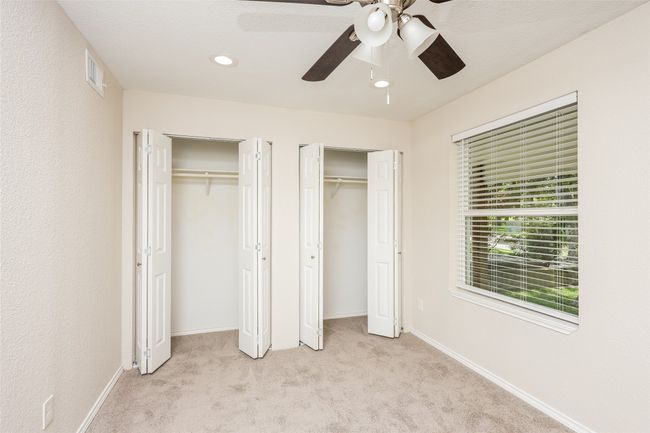 Unfurnished bedroom featuring two closets, light carpet, a ceiling fan, and recessed lighting | Image 21