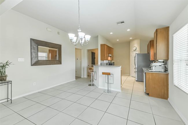 This view showcases the kitchen, breakfast area and living room's wonderful open concept design. | Image 13