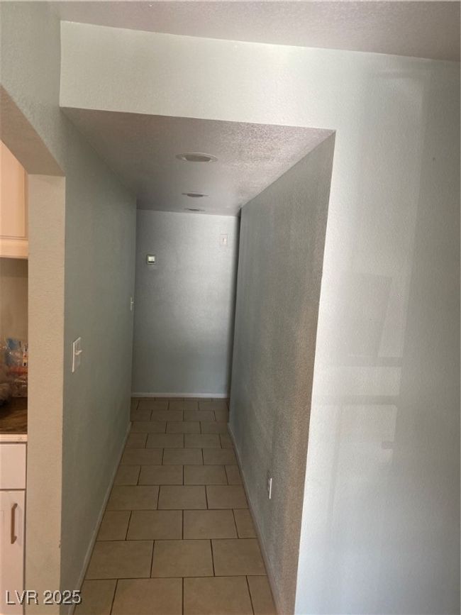 Corridor with baseboards and light tile patterned flooring | Image 4