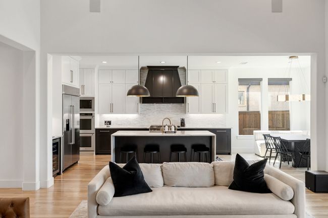 Living room featuring beverage cooler, light wood-style floors, and baseboards | Image 9