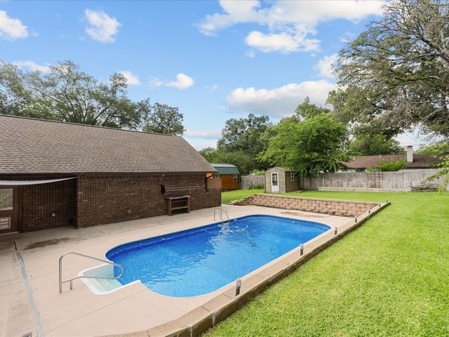 View of swimming pool with a patio area | Image 8