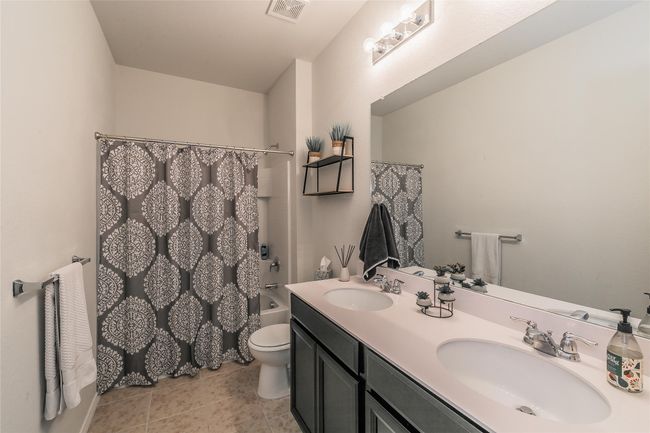 Full bathroom with vanity, toilet, and shower / bath combo | Image 9