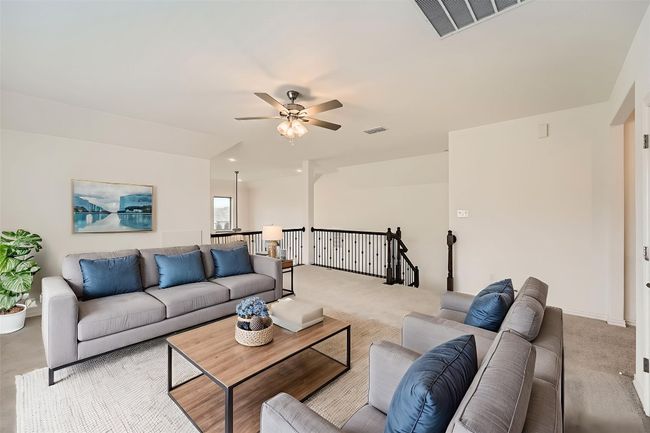 Carpeted living room featuring a ceiling fan | Image 29