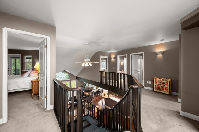Corridor with carpet flooring, an upstairs landing, and baseboards | Image 23