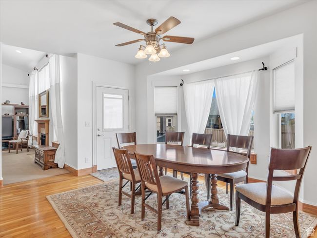 Dining area featuring recessed lighting, light wood finished floors, a ceiling fan, and baseboards | Image 14
