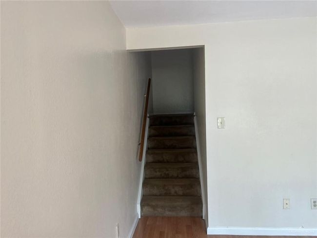 Stairway featuring wood finished floors and baseboards | Image 10