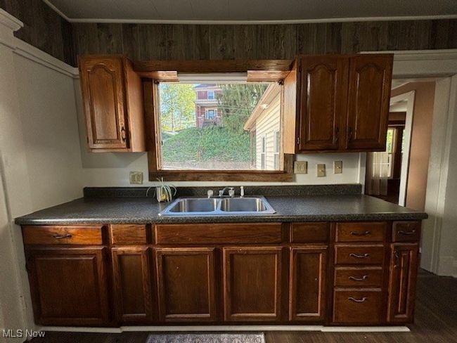 Kitchen featuring dark wood-type flooring and sink | Image 8