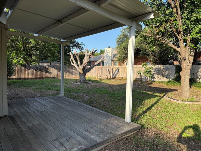 Wooden terrace with a fenced backyard | Image 21