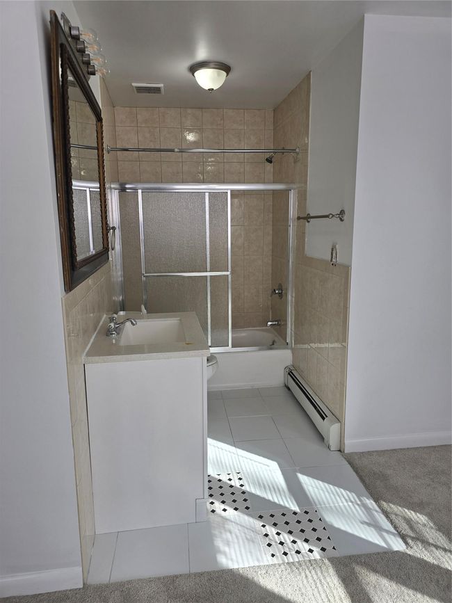 Bathroom featuring visible vents, toilet, a baseboard radiator, tile patterned flooring, and vanity | Image 18