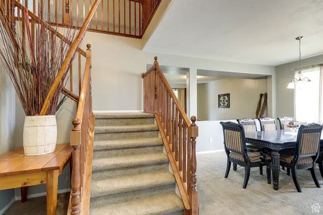 Dining area with baseboards, stairway, and light carpet | Image 8