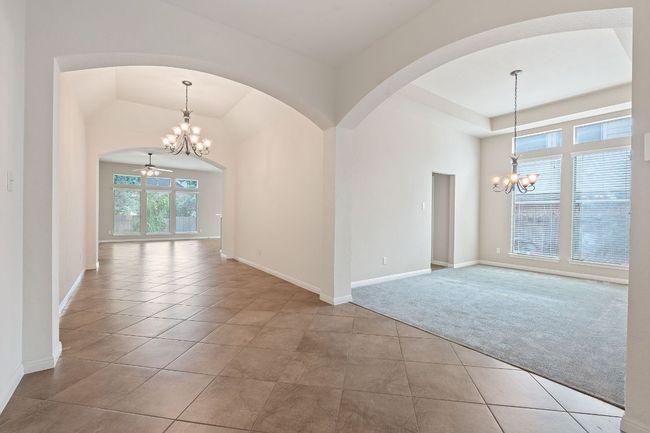 Wide entry with a chandelier, arched walkways | Image 8