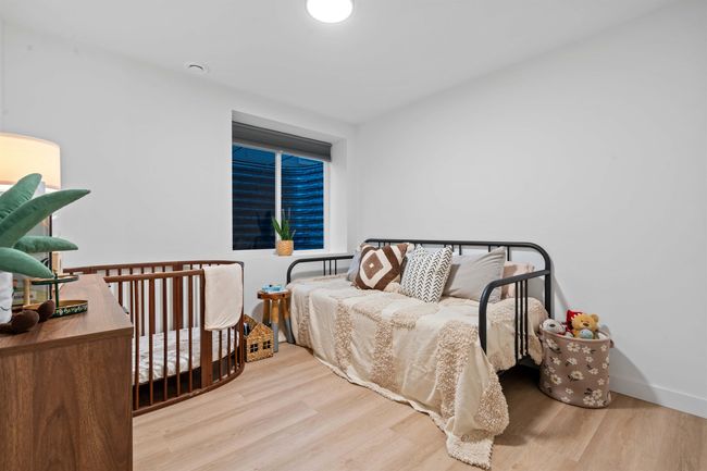 Bedroom with baseboards and wood finished floors | Image 36