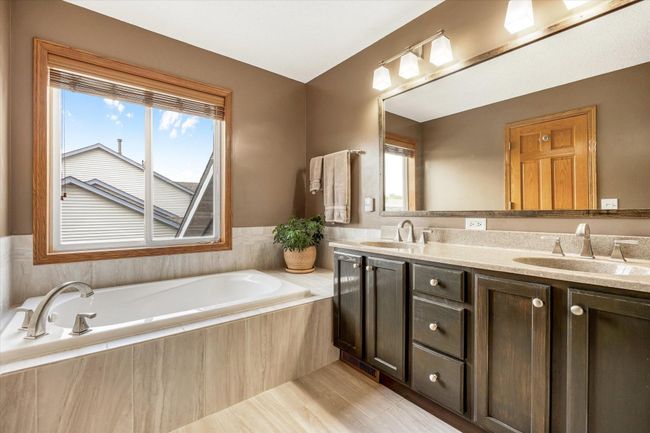 Primary bath, includes separate bath tub and shower, dual vanity, and heated floors. Updated within last year. | Image 26