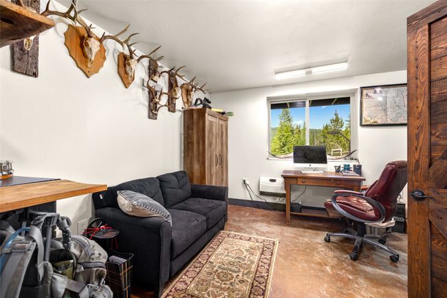 Home office featuring concrete flooring | Image 31