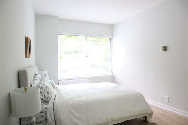 Bedroom featuring multiple windows and hardwood / wood-style flooring | Image 6