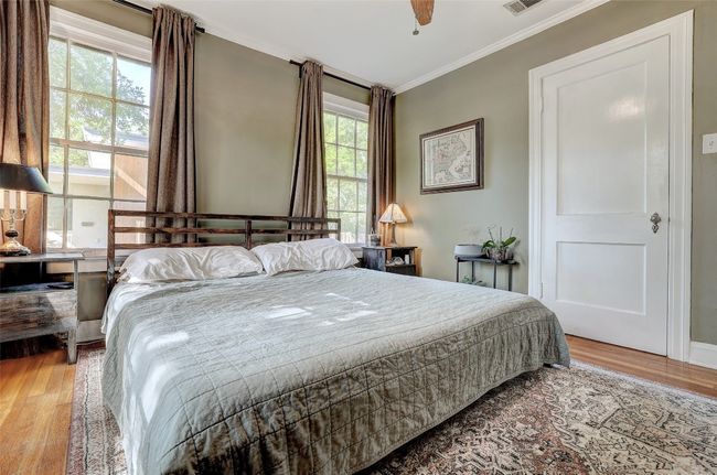 Bedroom featuring wood finished floors, visible vents, ceiling fan, and ornamental molding | Image 16