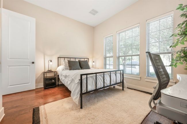 Bedroom with wood finished floors and baseboards | Image 6