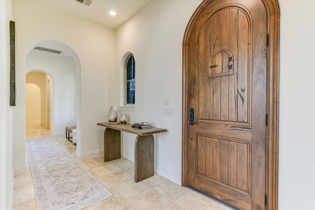 Foyer entrance with timeless arched walkway, recessed lighting, travertine flooring | Image 10