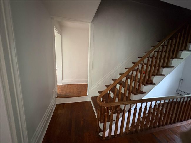 Stairway featuring wood finished floors and baseboards | Image 9