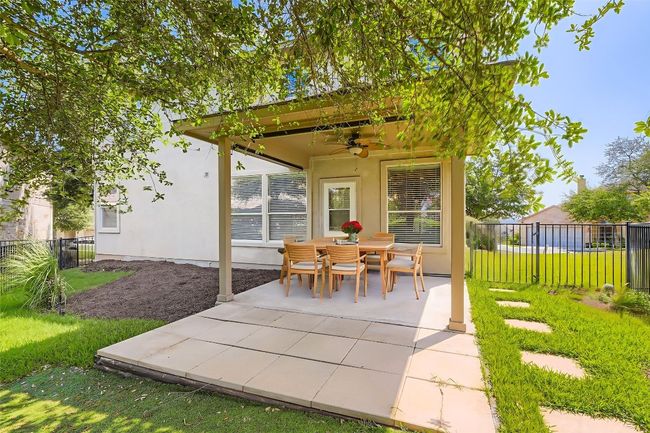 View of patio / terrace featuring a ceiling fan and outdoor dining area (virtual staging) | Image 8
