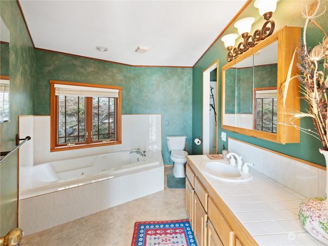 Jetted tub & walk-in shower in primary suite bath. | Image 25